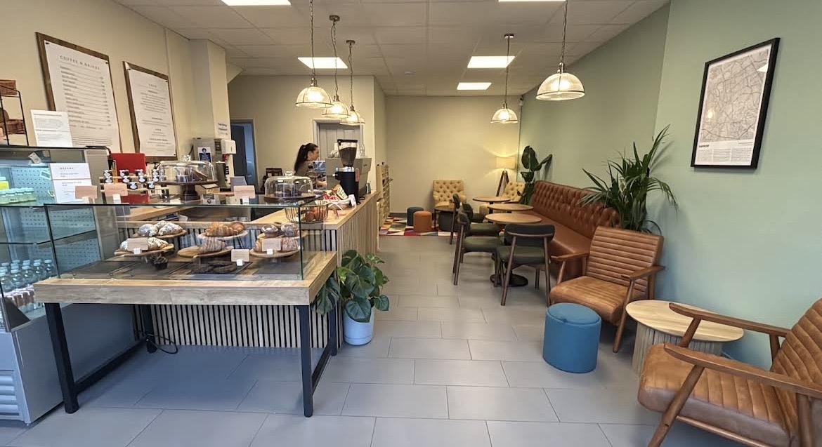 Warm seating and pastry counter inside Front Room Coffee