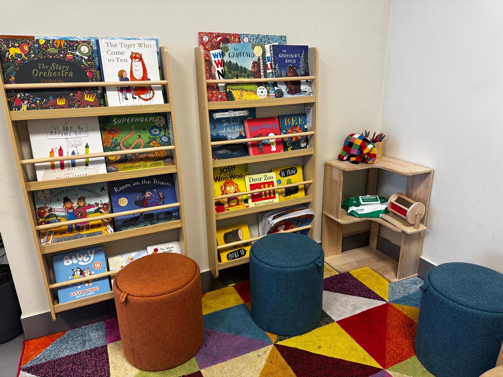 Front Room Coffee children’s corner with books, colourful seating and a wooden play station